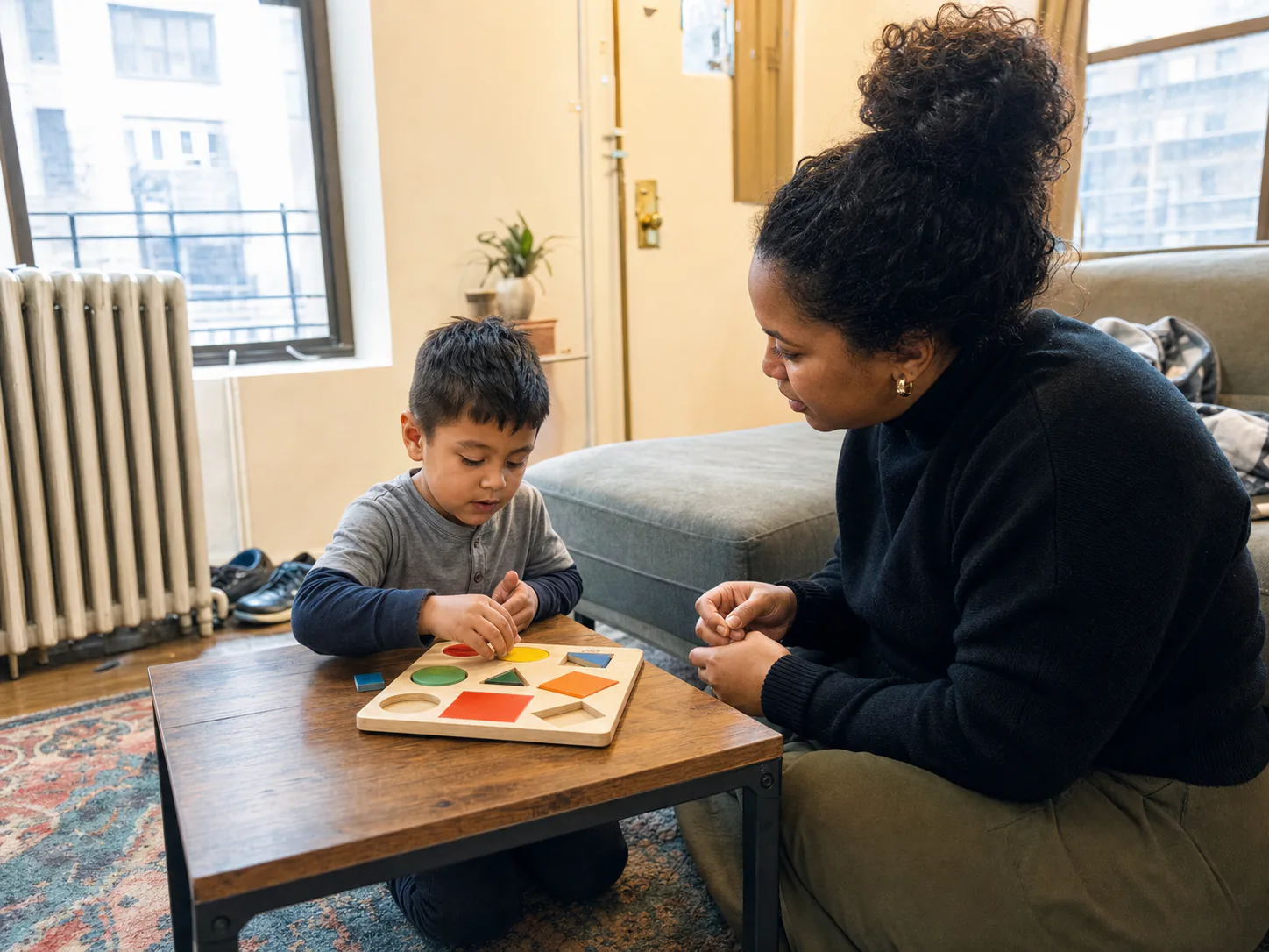 Child and therapist working together in a lived-in New Jersey apartment